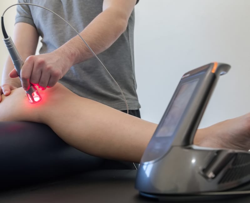 Laser therapy on a knee used to treat pain